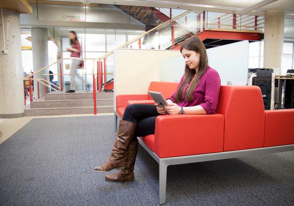 Student sitting in a lobby chair