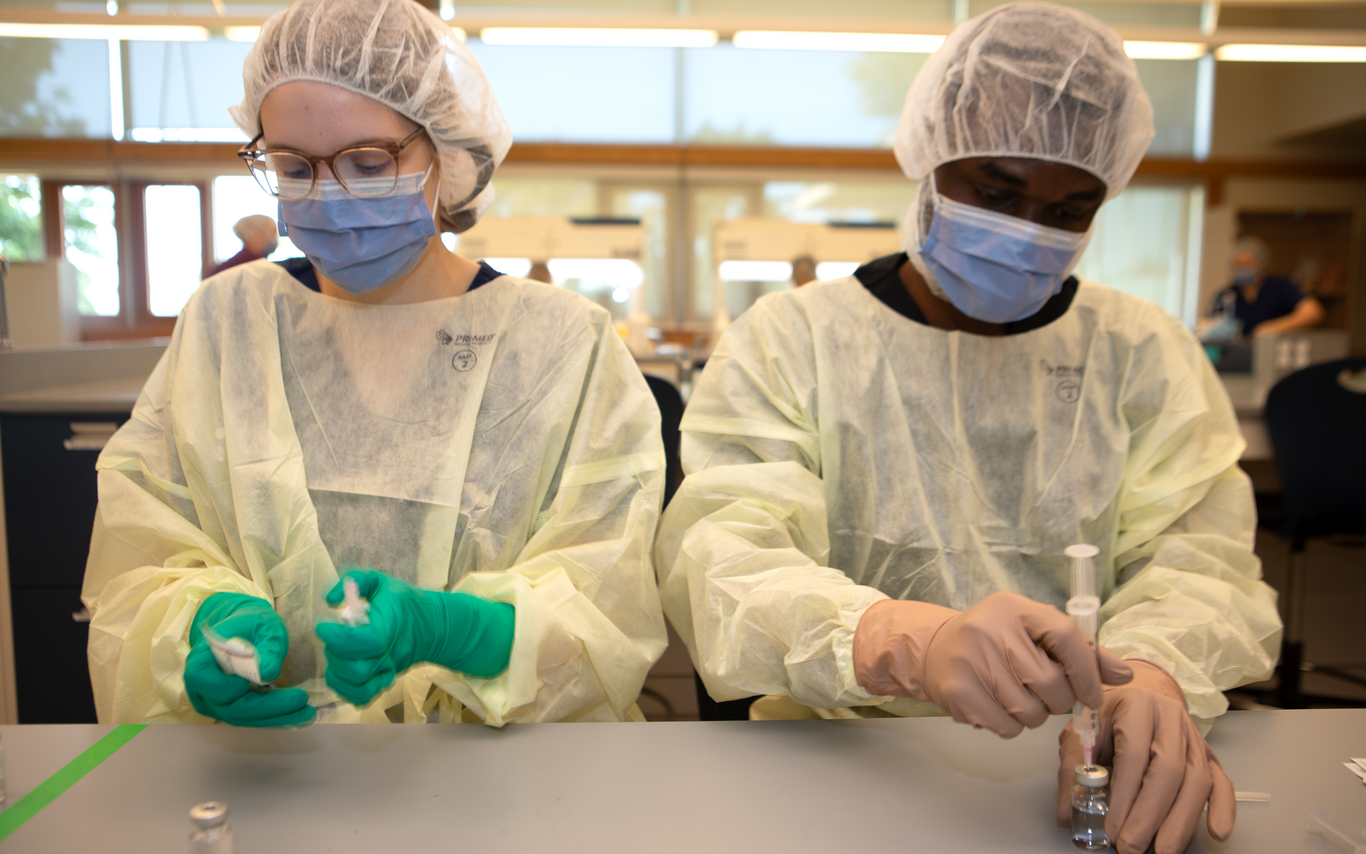 Two students working in a lab. 